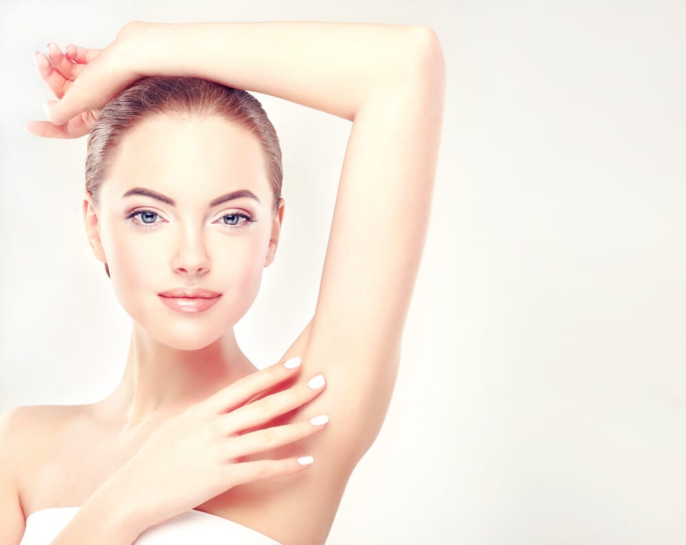 Woman touching her underarm