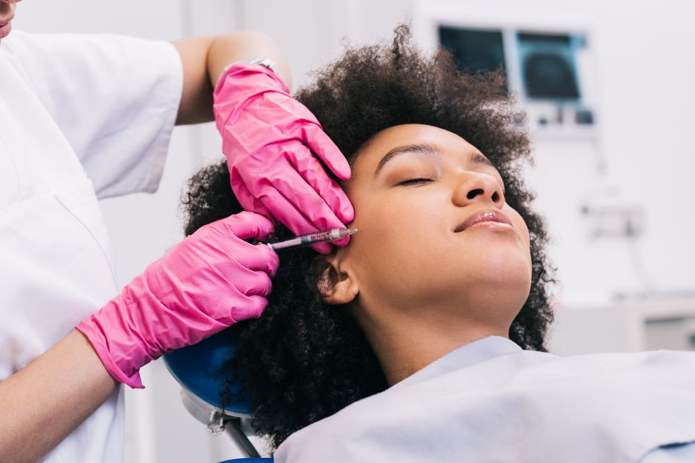 A woman receiving Botox treatment at a medical spa clinic.