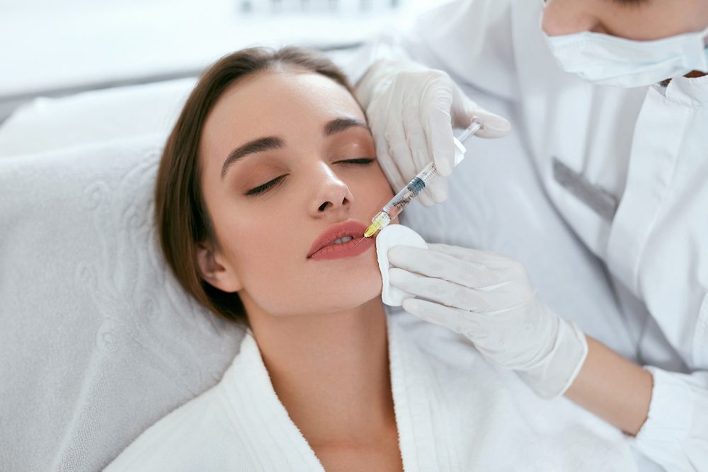 Lip Augmentation. Woman Getting Beauty Injection For Lips
