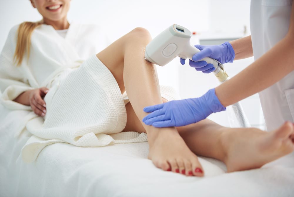 A woman receiving laser hair removal treatment at a clinic.
