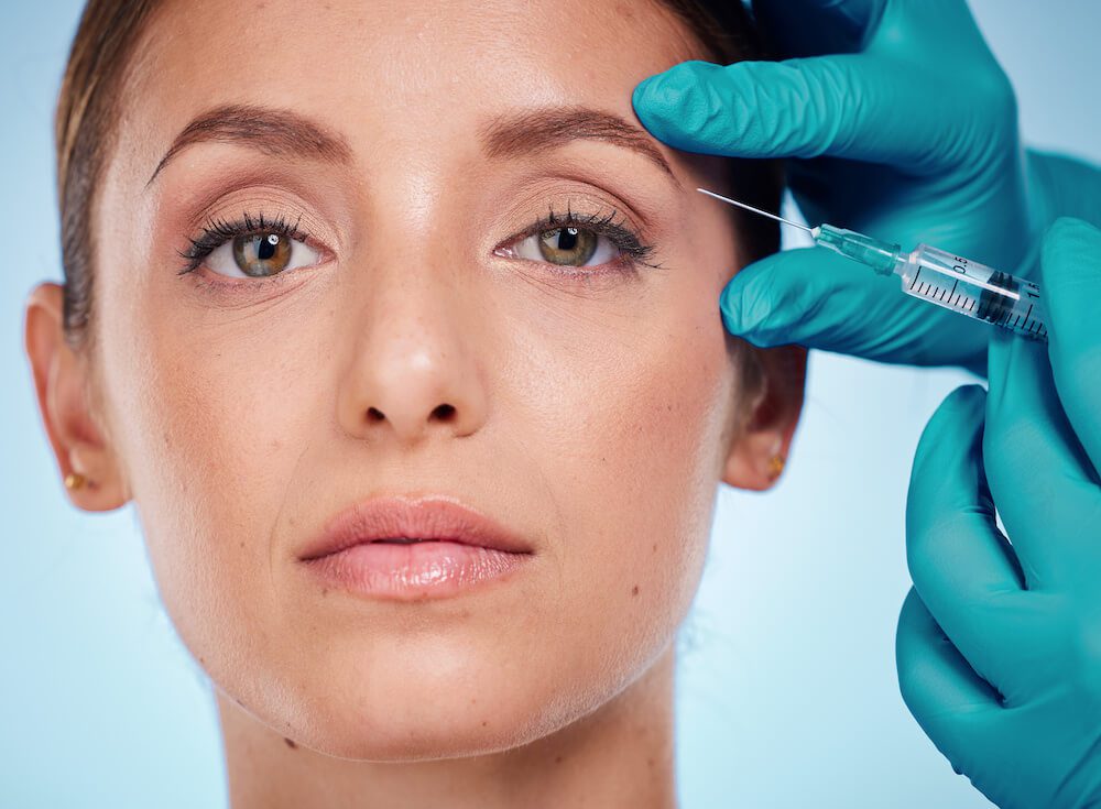 woman getting botox near her eyebrow to help with migraine relief