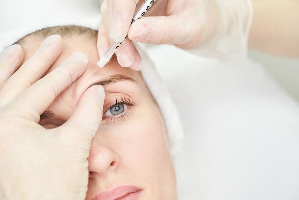 Woman getting restylane filler, closeup of the right side of her face