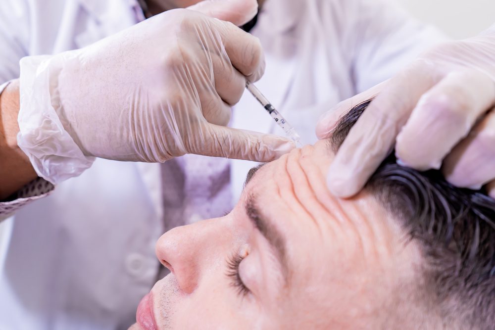 man getting botox after weighing the options of botox and dysport
