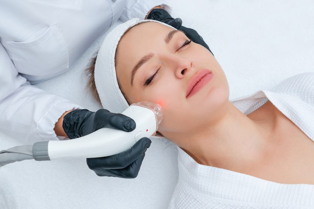 Young woman receiving laser hair removal treatment