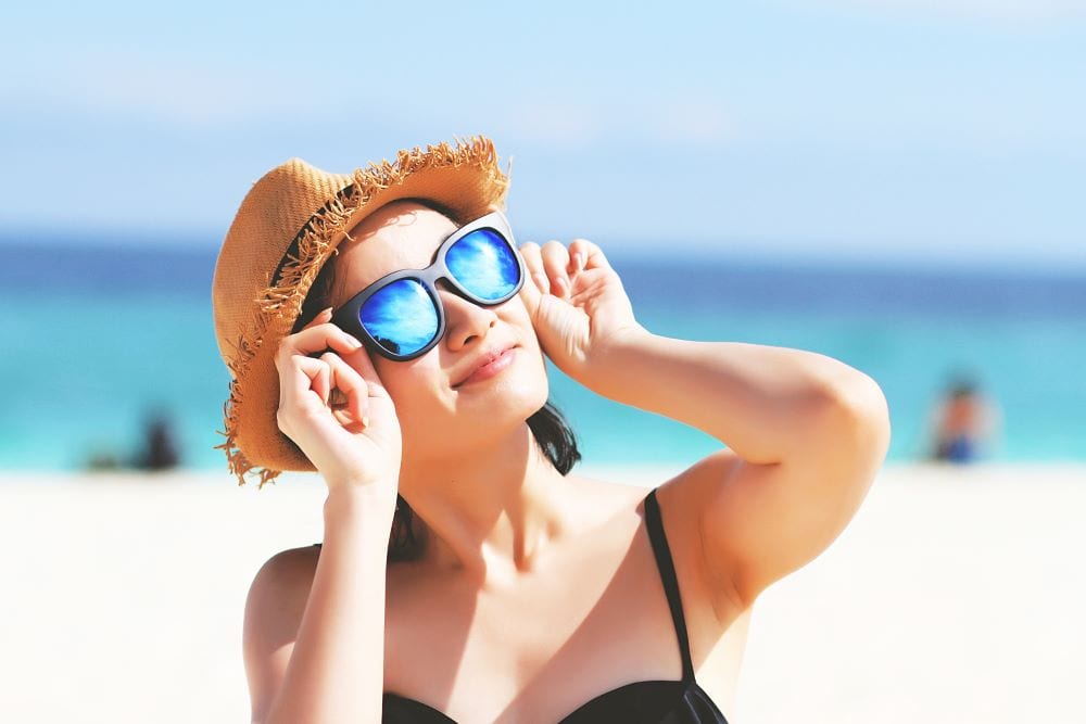 Woman on a beach wearing sunglass