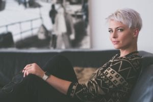 Short-haired woman sitting on couch
