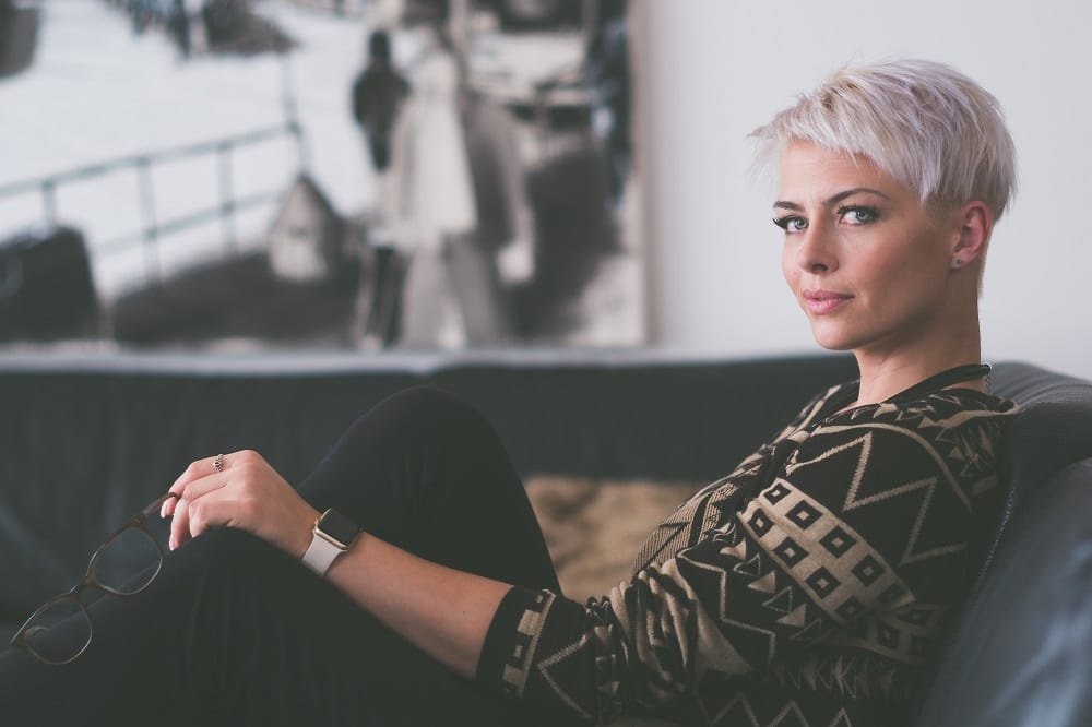 Short-haired woman sitting on couch